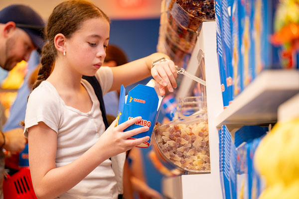 Shoppers create their own personalized candy blend at HARIBO’s Pick-and-Mix wall during the grand opening of the company’s first-ever U.S. retail store at Woodbury Common Premium Outlets in Central Valley, New York on Friday, August 7.